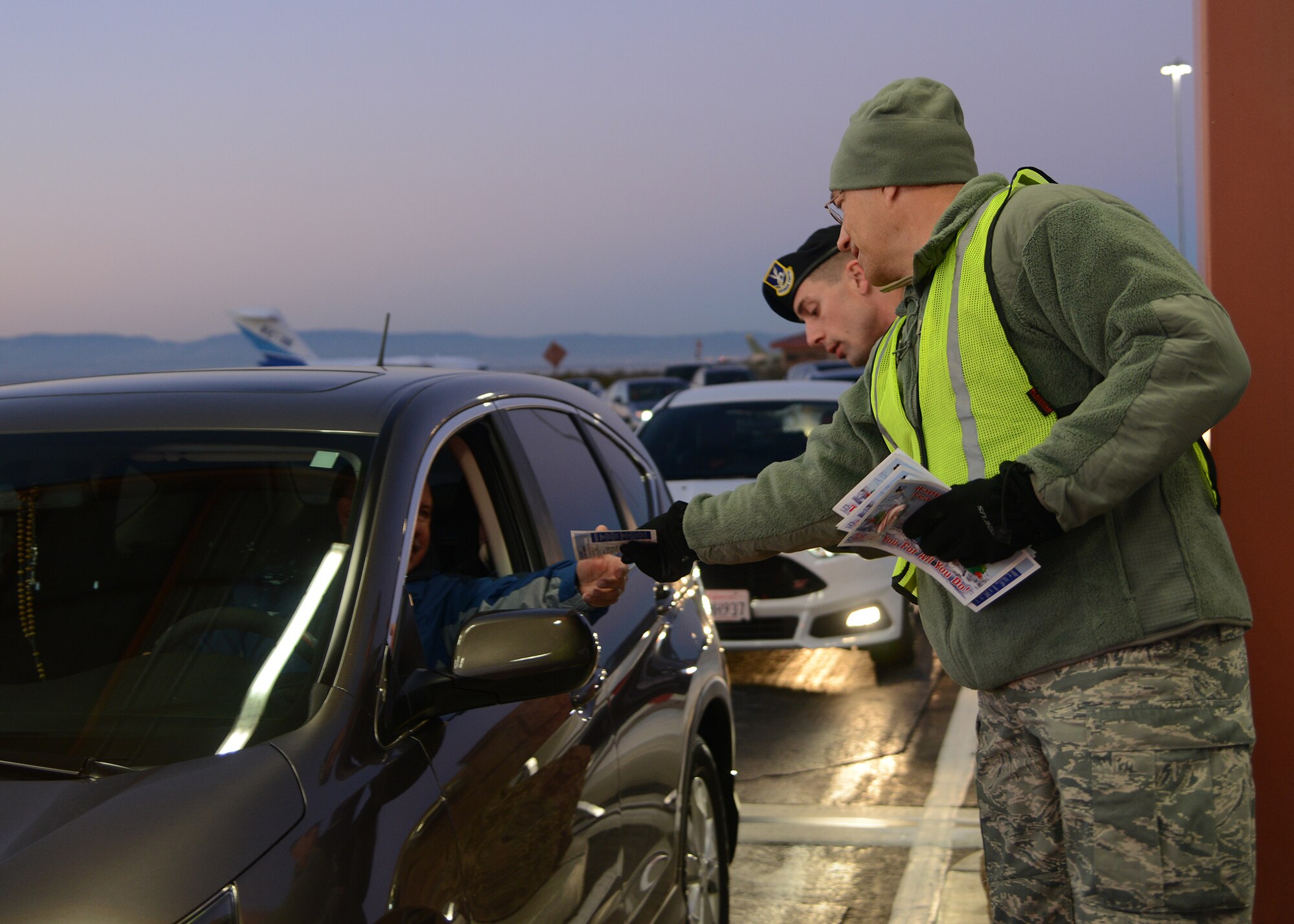 Col. David Radomski, 412th Test Wing vice commander, spent the early hours of Friday morning wishing base personnel happy holidays with other commanders at the West Gate. (U.S. Air Force photo by Rebecca Amber)