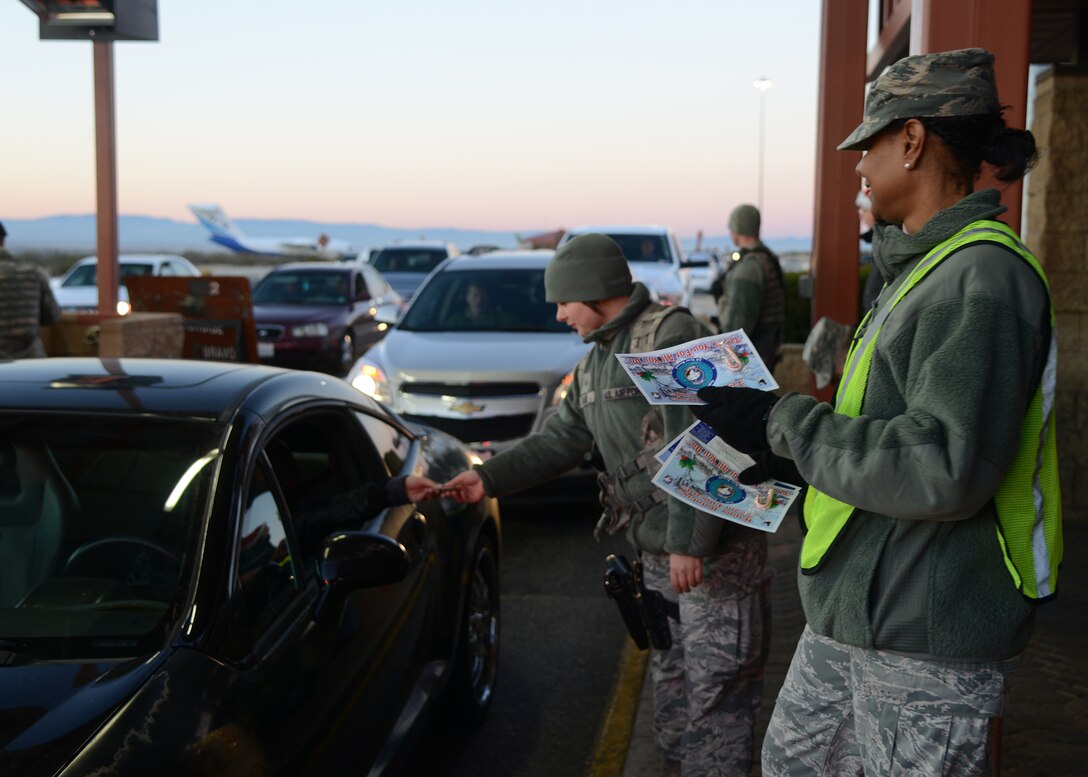 Col. Karen Cox-Dean, 412th Medical Group commander, joined 412th Test Wing Ground Safety and other commanders and Security Forces in handing out safety pamphlets and candy canes, wishing Team Edwards members a happy and safe holidays. (U.S. Air Force photo by Rebecca Amber)