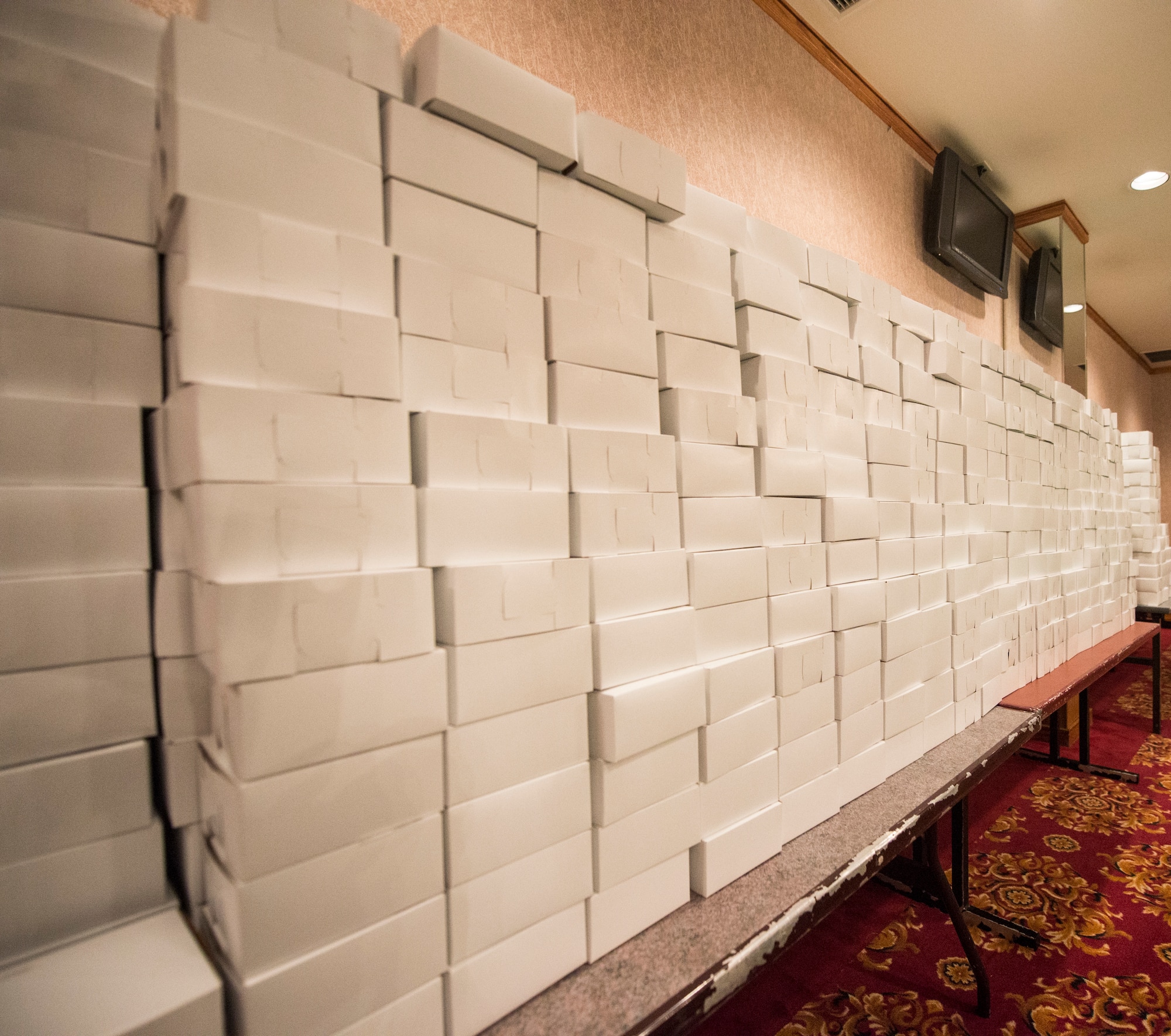 Boxes of cookies line the walls of the Rocker NCO club, Dec. 14, 2015, at the holiday cookie drive boxing site at Kadena Air Base, Japan. The holiday cookie drive is an annual event coordinated entirely by volunteers. Each year, thousands of cookies are donated and packaged for delivery to the single service members living in dormitories on Kadena. (U.S. Air Force photo by Senior Airman Omari Bernard)