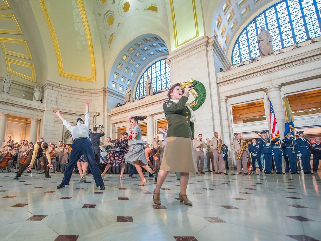 Technical Sergeant Paige Wroble sings out front during The USAF Band WWII Holiday Flashback at Union Station.  The special performance celebrated the service and sacrifices of our nation's World War II veterans and commemorated the 70th anniversary of the end of the war. (U.S. Air Force Photo by Lt Colonel Don Schofield/released)