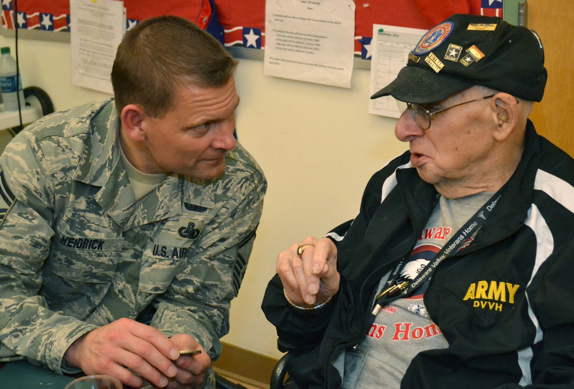 Senior Master Sgt. John Heidrick, the vehicle maintenance manager of the 111th Attack Wing at Horsham Air Guard Station, Pennsylvania, speaks with a resident of Delaware Valley Veterans' Home in Philadelphia, Pennsylvania, Dec. 17. 2015. Members of the Pa. National Guard visited two veterans' care facilities to spread holiday cheer (U.S. Air National Guard photo by Tech. Sgt. Andria Allmond/Released). 