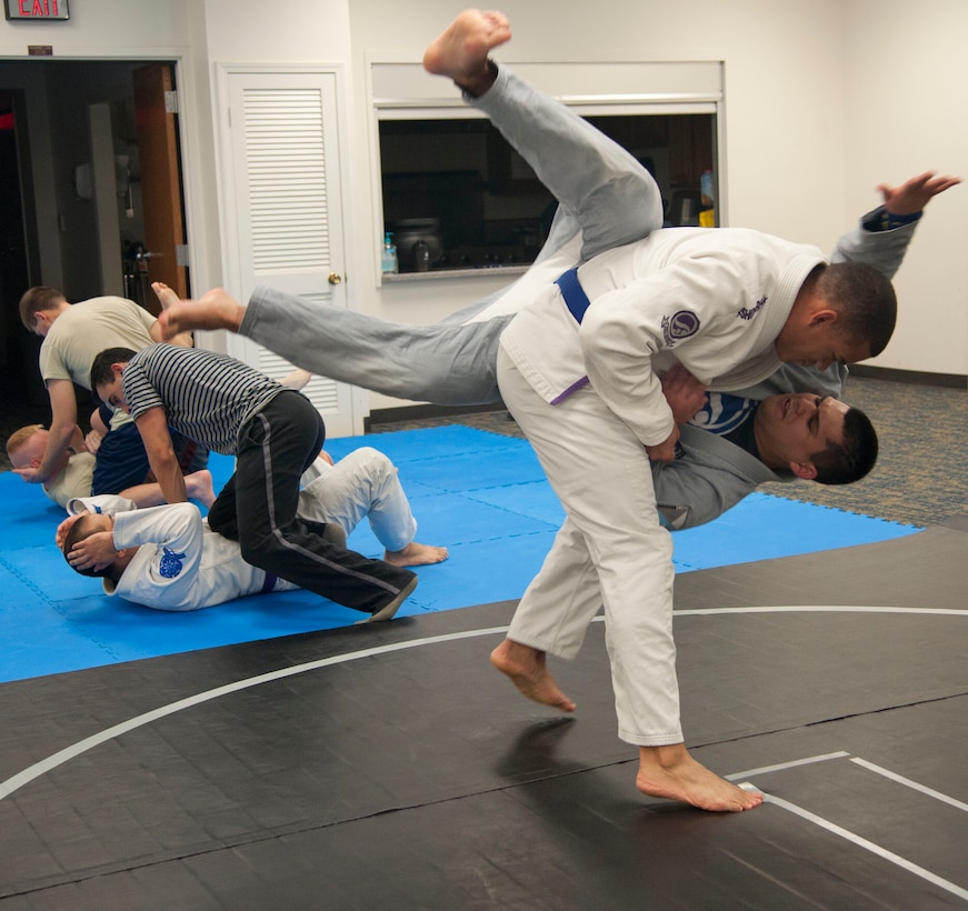 Senior Airman Justin Fisher throws Senior Airman Oscar Felix, both with the 71st Operations Support Squadron, to the ground during Brazilian Jiu Jitsu practice Nov. 19 at the Community Chapel Activities Center at Vance Air Force Base, Oklahoma. In class this throw was used to counter the attacker, Felix, who was grabbing or touching the upper body of the victim, Fisher. Jiu Jitsu, a form of martial arts, was bought to Vance nearly two years ago by Tech. Sgt. Tony Eclavea, a chaplain assistant with the 71st Flying Training Wing. (U.S. Air Force photo / Staff Sgt. Nancy Falcon)