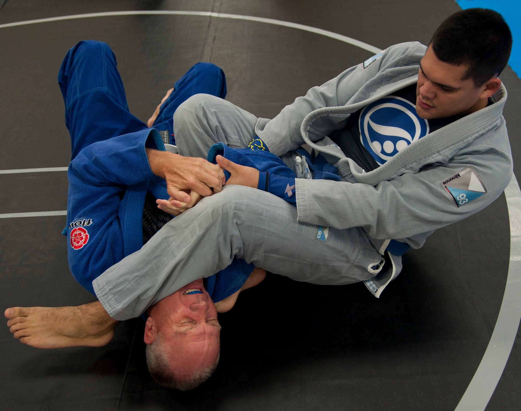Senior Airman Oscar Felix, an air traffic controller with the 71st Operations Support Squadron, grapples with retired Army Col. Paul Bischoff Nov. 19 at the Community Chapel Activity Center at Vance Air Force Base, Oklahoma. Jiu Jitsu, a form of martial arts, was bought to Vance nearly two years ago by Tech. Sgt. Tony Eclavea, a chaplain assistant with the 71st Flying Training Wing. (U.S. Air Force photo / Staff Sgt. Nancy Falcon)