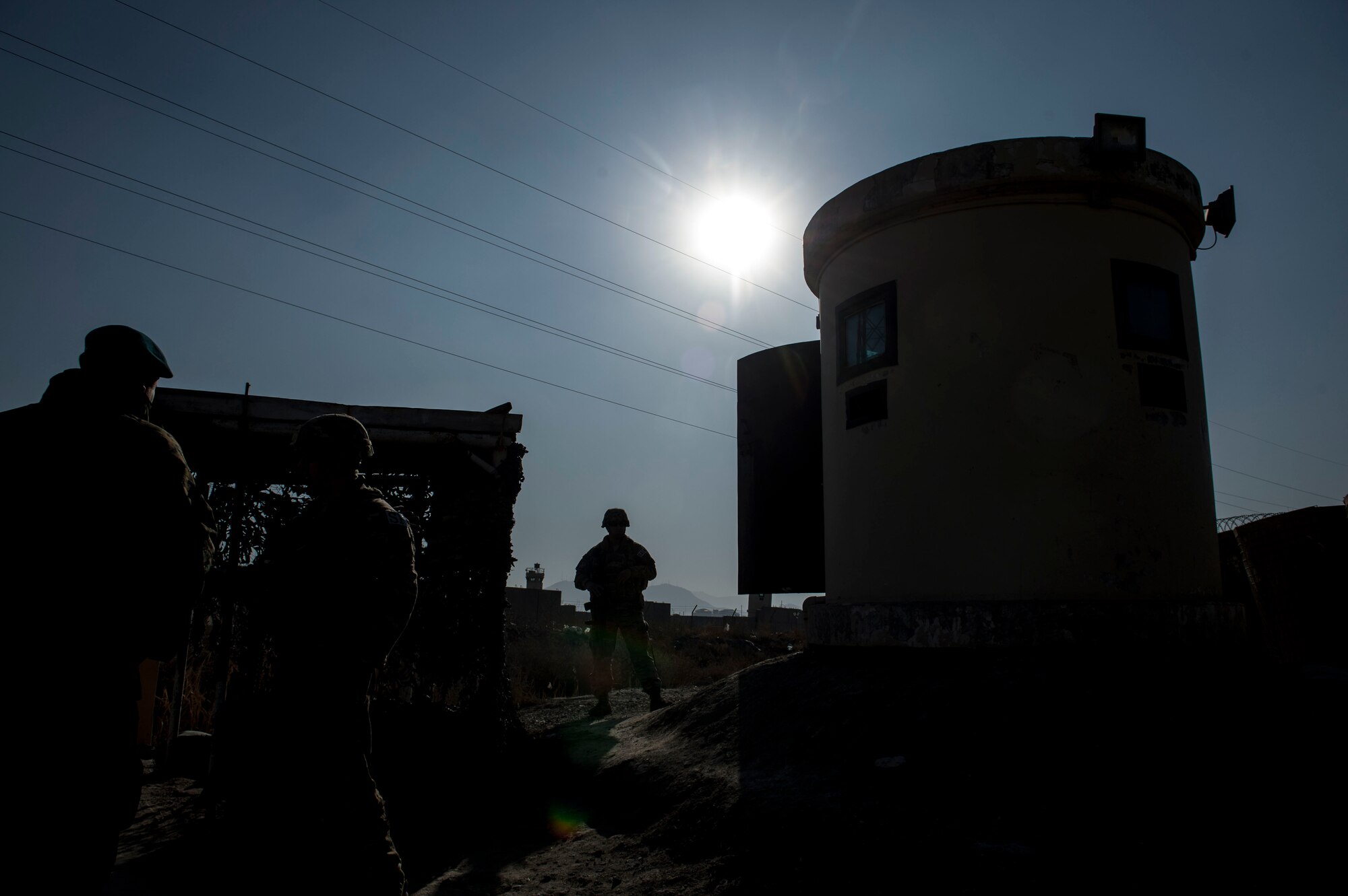 Train, Advise, Assist Command-Air (TAAC-Air) security forces advisors visit Afghan Air Force soldiers near a security post at Forward Operating Base Oqab, Kabul, Afghanistan, Dec. 13, 2015. TAAC-Air advisors have grown the Afghan Air Force since 2006. During this time, the Afghan Air Force has made daily strides toward becoming a professional, capable and sustainable Air Force. (U.S. Air Force photo by Staff Sgt. Corey Hook/Released) 