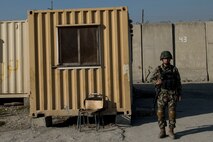 An Afghan Air Force soldier stands near his living quarters near Forward Operating Base Oqab, Kabul, Afghanistan, Dec. 13, 2015. Train, Advise, Assist Command-Air (TAAC-Air) advisors have grown the Afghan Air Force since 2006. During this time, the Afghan Air Force has made daily strides toward becoming a professional, capable and sustainable Air Force. (U.S. Air Force photo by Staff Sgt. Corey Hook/Released)