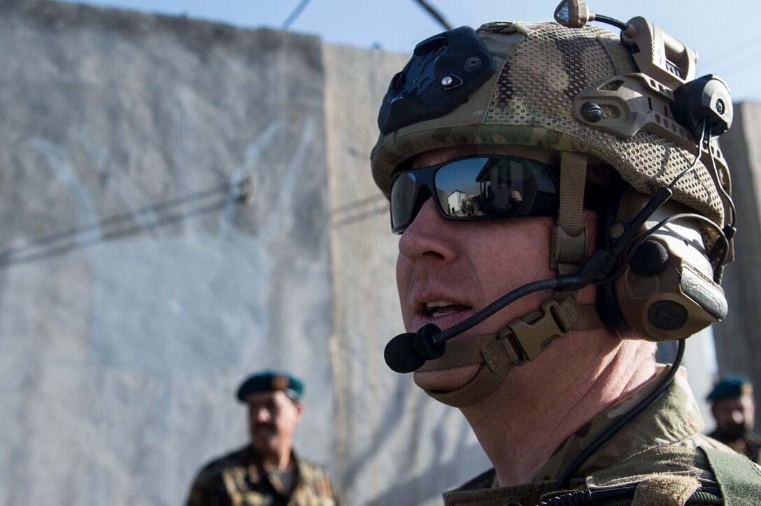 U.S Air Force Capt. Ryan Kiggins visits with Afghan Air Force solders near Forward Operating Base Oqab, Kabul, Afghanistan, Dec. 13, 2015. Kiggens is assigned to the Train, Advise, Assist Command-Air (TAAC-Air) security forces as an advisor. (U.S. Air Force photo by Staff Sgt. Corey Hook/Released) 