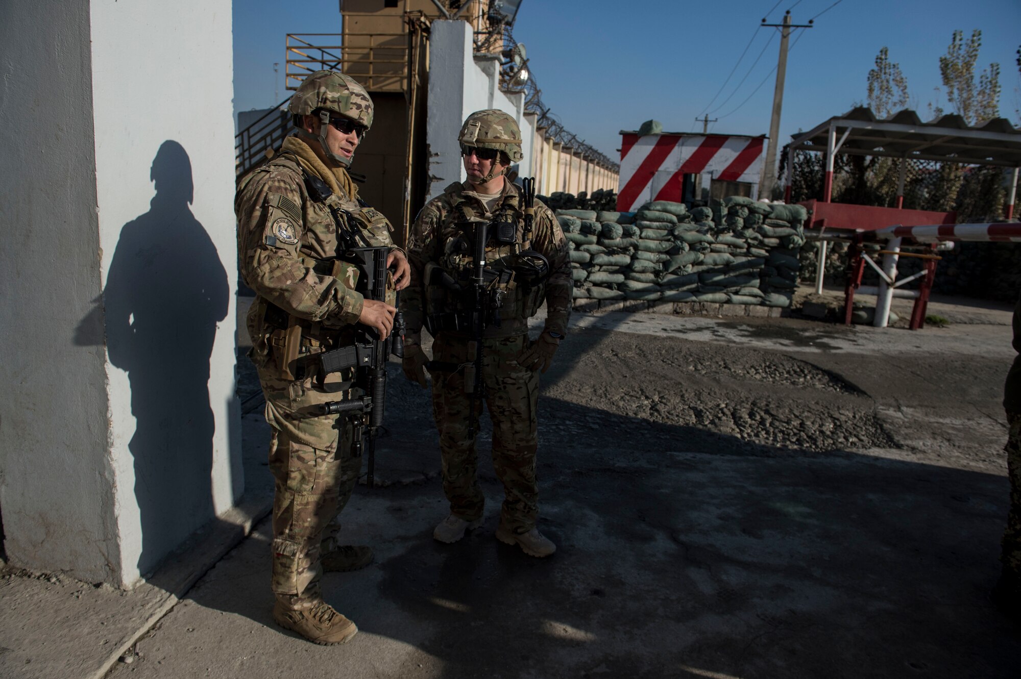 (Left) U.S Air Force Staff Sgt. Staff Sgt. Mark Saldana and Tech. Sgt. Beau Hanson have a conversation near Forward Operating Base Oqab, Kabul, Afghanistan, Dec. 13, 2015. Saldana and Hanson are assigned to Train, Advise, Assist Command-Air (TAAC-Air) security forces as advisors.  (U.S. Air Force photo by Staff Sgt. Corey Hook/Released)