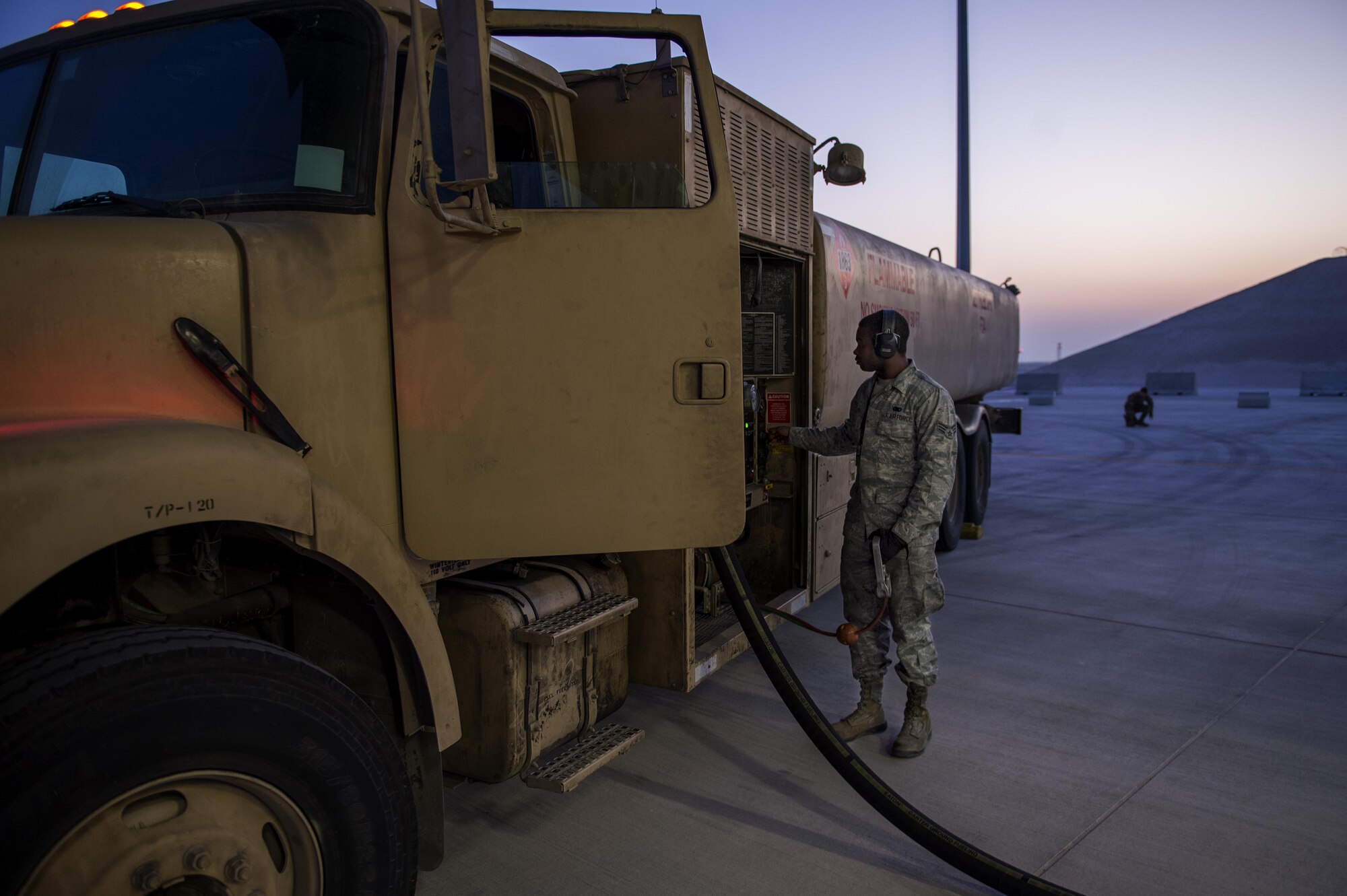 U.S. Air Force Senior Airman Jerrell Smith from the 379th Expeditionary Logistics Readiness Squadron fills fuel bladders on a C-17 Globemaster, Dec. 16, 2015, at Al Udeid Air Base, Qatar. The fuel was transported in support of Operation Inherent Resolve to coalition bases in Iraq. (U.S. Air Force photo by Tech. Sgt. Nathan Lipscomb)