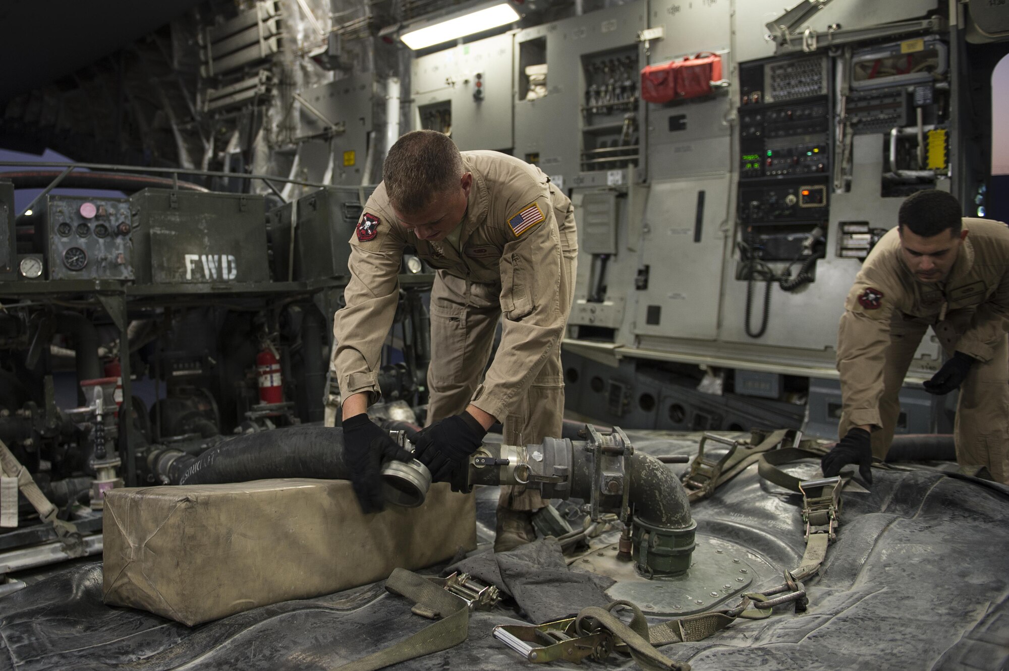 U.S. Air Force Senior Airmen Dalton Lobato, right, and Benjamin Hunter, 379th Expeditionary Logistics Readiness Squadron aerial bulk fuels delivery system team members, fill fuel bladders for transport to coalition bases in Iraq in support of Operation Inherent Resolve, Dec. 16, 2015. OIR is the coalition intervention against the Islamic State of Iraq and the Levant. (U.S. Air Force photo by Tech. Sgt. Nathan Lipscomb)