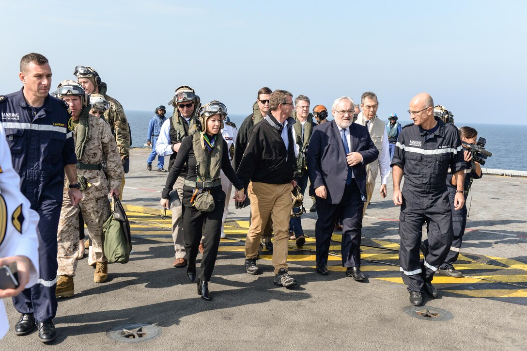 U.S. Defense Secretary Ash Carter and his wife, Stephanie, arrive on the deck of the  flagship of the French Navy the Charles de Gaulle on Dec. 19, 2015. Carter is on a weeklong trip in which he is visiting leaders and deployed service members in the Middle East and Afghanistan. DoD photo by Army Sgt. 1st Class Clydell Kinchen