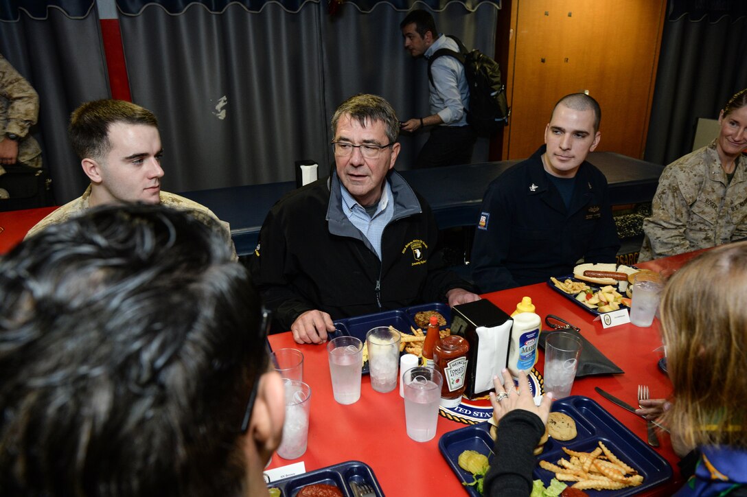 U.S. Defense Secretary Ash Carter speaks with sailors and Marines while having lunch with them during his visit aboard the amphibious assault ship USS Kearsarge in the Arabian Gulf, Dec. 19, 2015. U.S. DoD photo by Army Sgt. 1st Class Clydell Kinchen