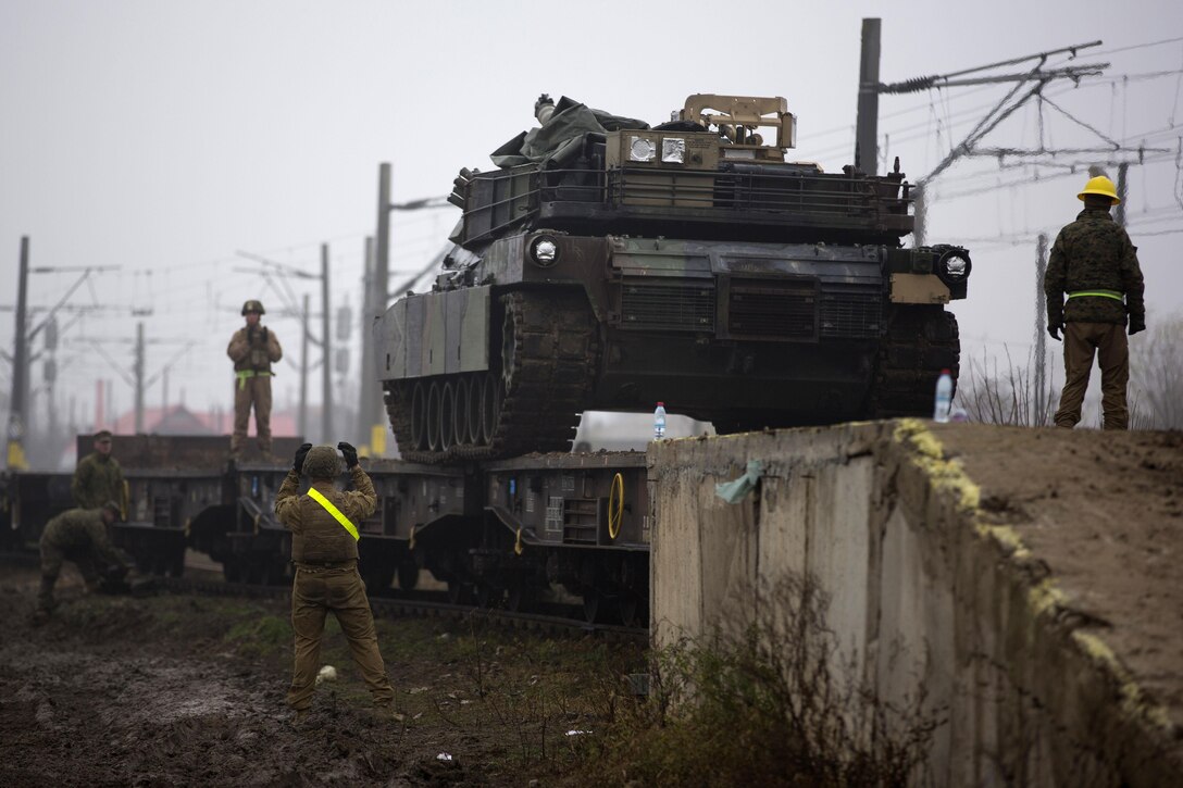 U.S. Marines unload an M1A1 tank from a rail car at Bethesda rail station in Romania, Dec. 6, 2015. U.S. Marine Corps photo by Lance Cpl. Melanye E. Martinez