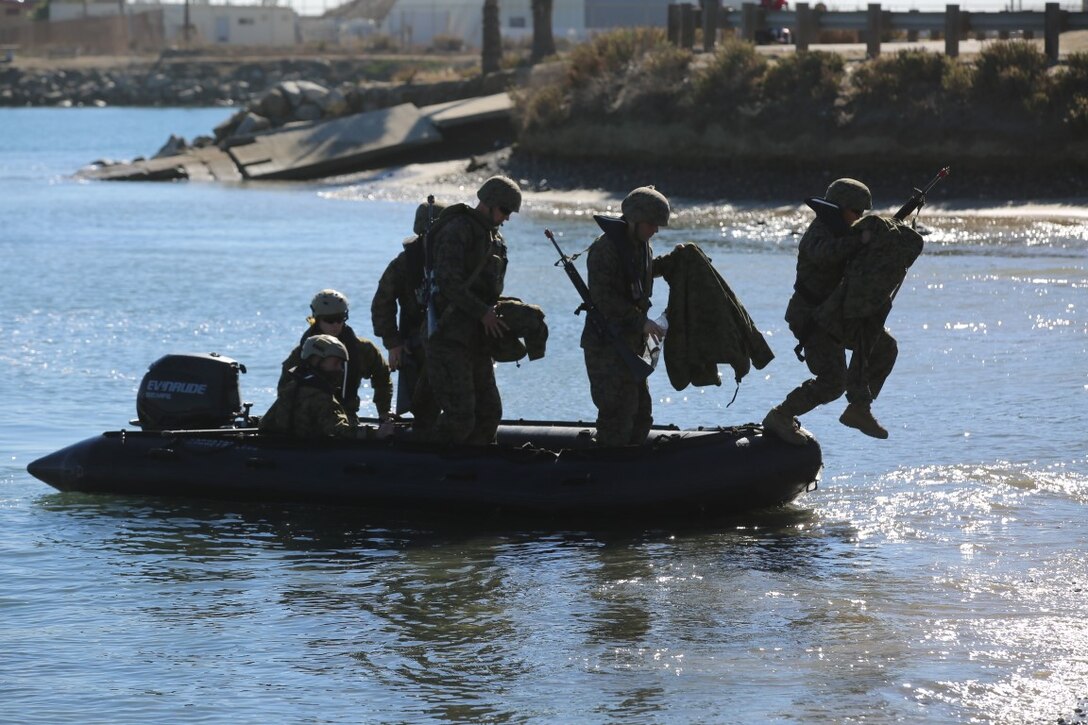 Marines from Bridge Company, 7th Engineer Support Battalion, Combat Logistics Regiment 1, 1st Marine Logistics Group depart from a Rigid Hulled Inflatable Boat during sustainment training in tandem with Marines from 6th ESB out of Battle Creek, Mich., aboard Marine Corps Base Camp Pendleton, Dec. 12, 2015. Training included the assembling of Mark III Improved Ribbon Bridges for shore-to-shore bridge building operations and water borne logistical support with troop debarkation.