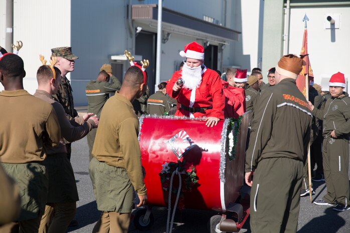 Marines with Combat Logistics Company 36 inspect Santa’s sleigh before kicking off the annual 1.5k Jingle Bell Jog at the IronWorks Gym, Marine Corps Air Station Iwakuni, Japan, Dec. 18, 2015. The Jingle Bell Jog is an event for service members and their families to show off their holiday spirit as they run through the station. Events like this help raise spirits and build camaraderie during the holiday season while most service members are away from their families.