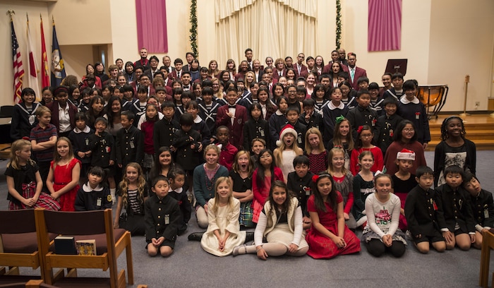 Matthew C. Perry School students and Japanese students pose for a photo at the annual holiday concert at Marine Memorial Chapel at Marine Corps Air Station Iwakuni, Japan, Dec. 8, 2015. The American and Japanese students prepared and sang a number of holiday songs in both Japanese and English.