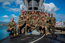 Marines and Sailors with Company A, 1st Reconnaissance Battalion, 1st Marine Division, pose for a photo atop of the USS Mississippi, a Virginia Class Block 5 submarine aboard Joint Base Pearl Harbor-Hickam, Hawaii, Nov. 17, 2015. Company A toured the ship as part of a one-day Special Operations Forces capabilities training event, where they learned about lock-out submarine insertions. (U.S. Marine Corps Photo by Sgt. Tony Simmons)