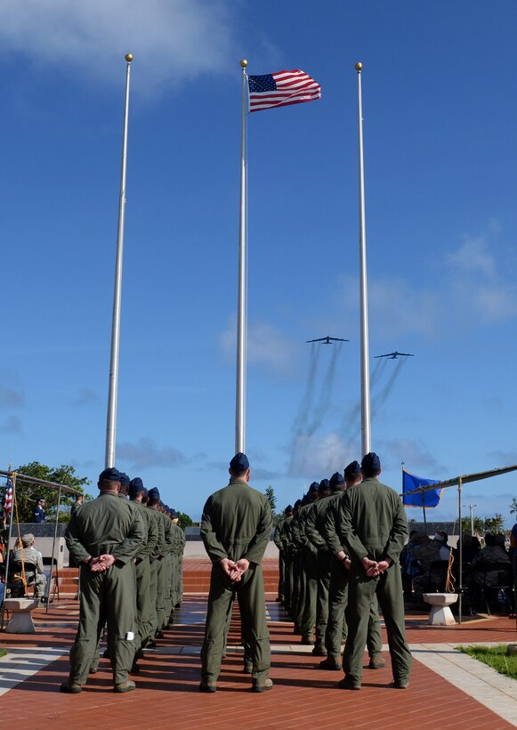 Aviators from the 23rd Expeditionary Bomb Squadron stand at parade rest as two B-52 Stratofortresses conduct a flyover during the Linebacker II Remembrance Ceremony Dec. 18, 2015, at Andersen Air Force Base, Guam. During Operation Linebacker II, more than 700 B-52 bombing campaigns were conducted out of Andersen. (U.S. Air Force photo/Staff Sgt. Benjamin Gonsier)