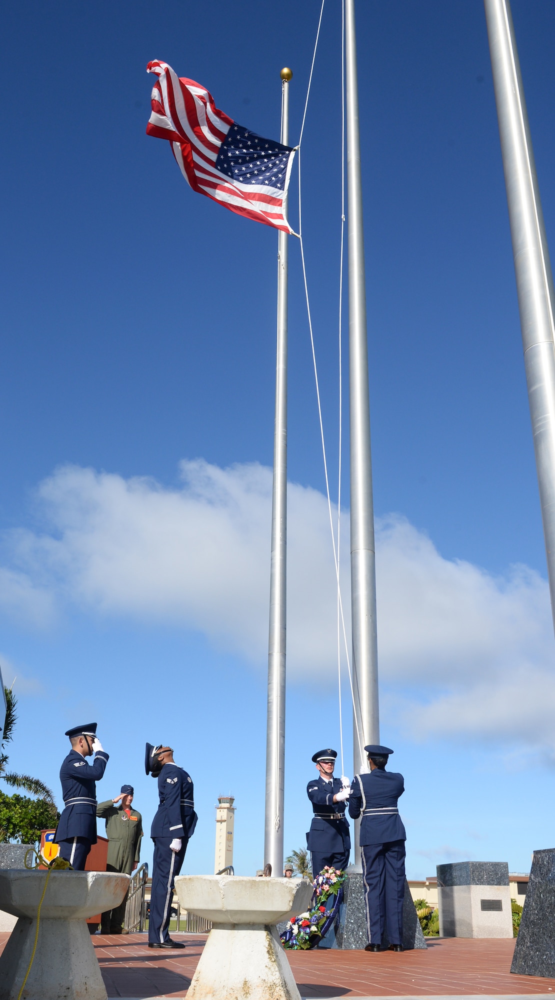 Andersen Blue Knights lower the flag to half-staff during the Linebacker II Remembrance Ceremony Dec. 18, 2015, at Andersen Air Force Base, Guam. The flag will be placed at half-staff for 11 days, signifying the number of days the Linebacker II bombing campaign lasted. (U.S. Air Force photo/Staff Sgt. Benjamin Gonsier)