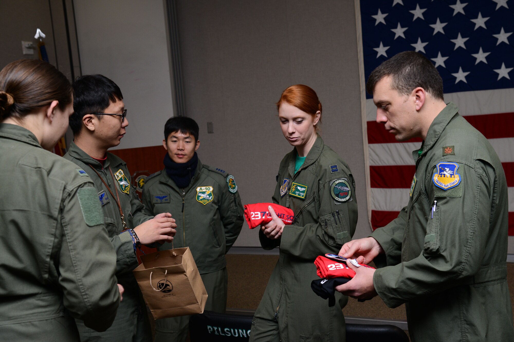 U.S. Air Force and Republic of Korea air force pilots exchange squadron gifts during Buddy Wing 15-8 at Osan Air Base, ROK, Dec. 18, 2015. The pilots exchanged their squadron’s patches and t-shirts before the ROKAF pilots depart Osan. (U.S. Air Force photo/Airman 1st Class Dillian Bamman)