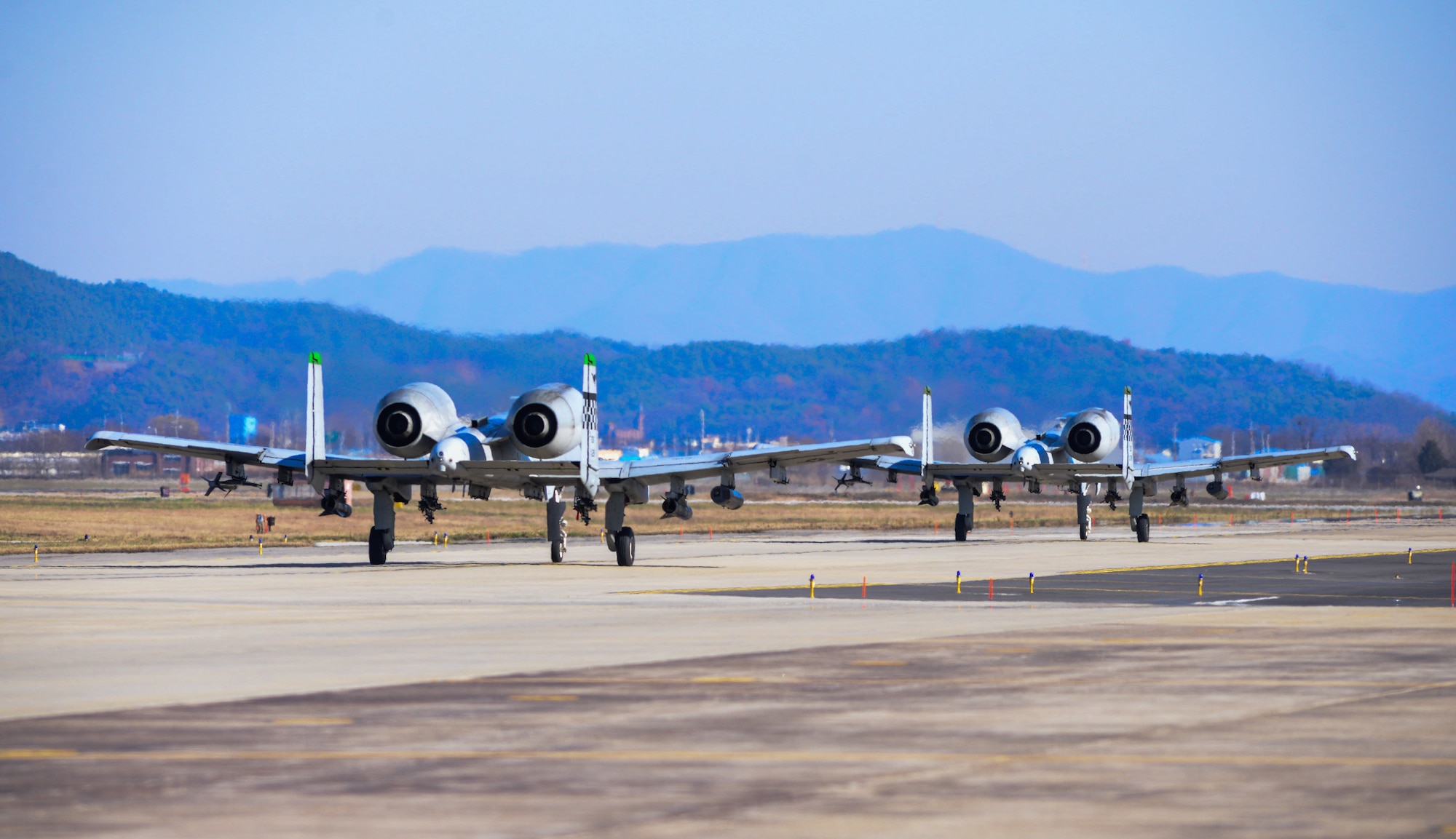 A-10 Thunderbolt IIs taxi on the flightline after a forward air control training mission during Buddy Wing 15-8 at Osan Air Base, Republic of Korea, Dec. 17, 2015. U.S. Air Force and ROKAF pilots performed FAC missions simultaneously to ensure interoperability. (U.S. Air Force photo/Airman 1st Class Dillian Bamman)