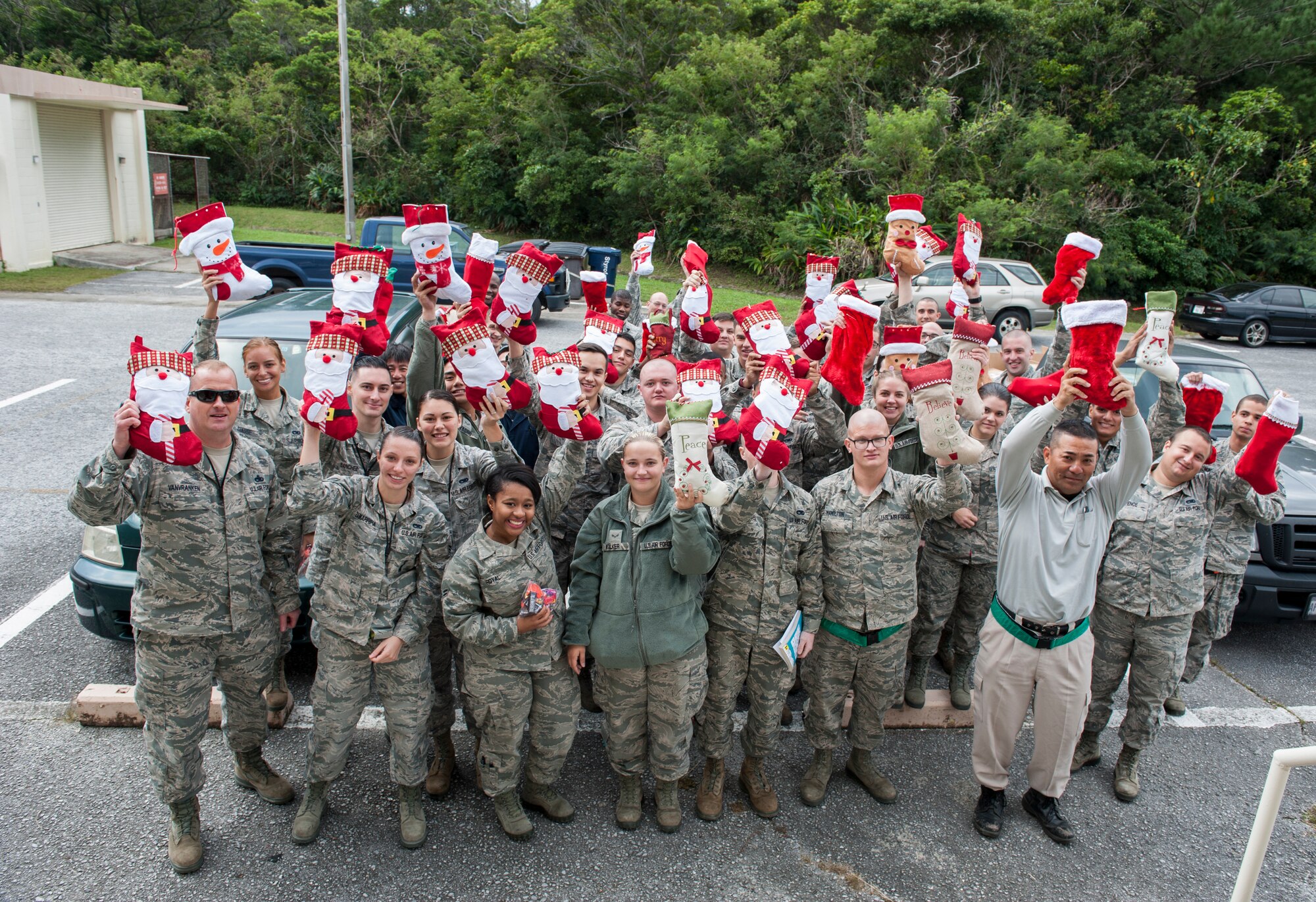 Members of the 18th Munitions Squadron Munitions Storage Unit proudly show their Christmas stockings Dec. 17, 2015, at Kadena Air Base, Japan. They received these stockings from Boatsie’s Boxes as early Christmas presents. Boatsie’s Boxes Inc. delivered approximately 300 stockings to Kadena. (U.S. Air Force photo by Airman 1st Class Lynette M. Rolen)