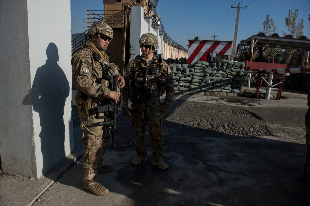 U.S. Air Force Tech. Sgts. Mark Saldana, left, and Beau Hanson discuss security issues during a visit with Afghan airmen near Forward Operating Base Oqab in Kabul, Afghanistan, Dec. 13, 2015. U.S. Air Force photo by Staff Sgt. Corey Hook