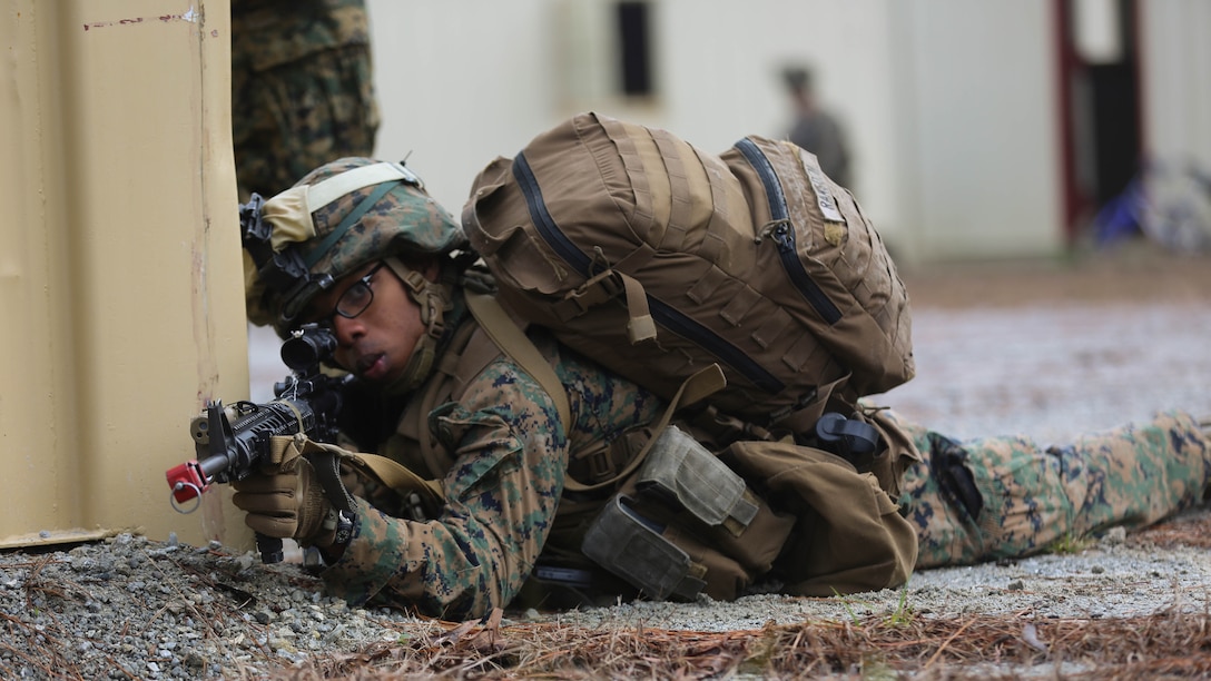 Lance Cpl. James Ramsden, a rifleman with 3rd Battalion, 6th Marine Regiment, holds a security position during a limited objective experiment at Marine Corps Base Camp Lejeune, N.C., Dec. 8, 2015. The Marine Corps Warfighting Laboratory worked with 3rd Bn., 6th Marines, and 1st Battalion, 10th Marine Regiment, to test artillery and infantry integration tactics. During the experiment, the company landing team attacked from near the Onslow Beach landing site towards the objective of the Military Operation in Urban Terrain training center. 