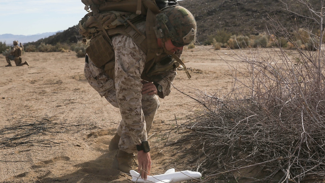 Gunnery Sgt. David Crosby retrieves a simulated downed unmanned aerial vehicle during the Tactical Recovery of Aircraft and Personnel portion of a Marine Corps Combat Readiness Evaluation of 2nd Battalion, 7th Marine Regiment, at Marine Corps Air Ground Combat Center Twentynine Palms, Calif., Dec. 3, 2015. TRAP’s placement in a MCCRE is meant to evaluate Marines on this mission set which is performed for the specific purpose of the recovery of personnel, equipment, and/or aircraft by the insertion of a TRAP force. Gunnery Sgt. Crosby is an explosive ordnance disposal technician with 7th Engineer Support Battalion, 1st Marine Logistics Group. 