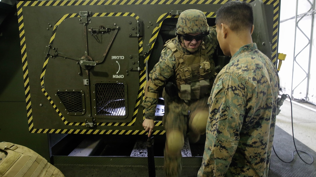 A Marine with 2nd Supply Battalion, 2nd Marine Logistics Group climbs out of a Humvee Egress Assistance Trainer simulator during a class at Marine Corps Base Camp Lejeune, N.C., Dec. 17, 2015. The HEAT class is designed to show Marines what to do if a vehicle rolls over during low visibility, no visibility, or experiences sideways or 180-degree rollovers. 