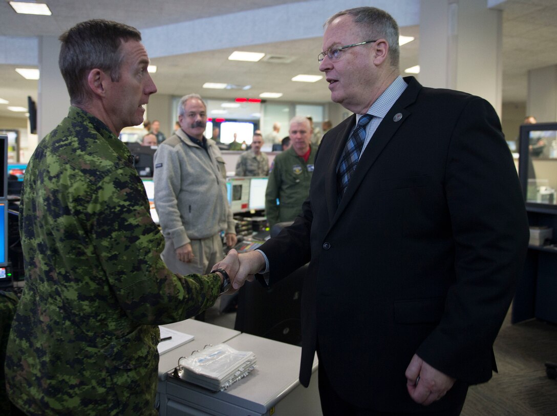 Deputy Defense Secretary Bob Work greets a Canadian service member at U.S. Northern Command on Peterson Air Force Base, Colo., Dec 18, 2015. Work is in Colorado to meet with defense leaders and tour local commands. DoD photo by Navy Petty Officer 1st Class Tim D. Godbee