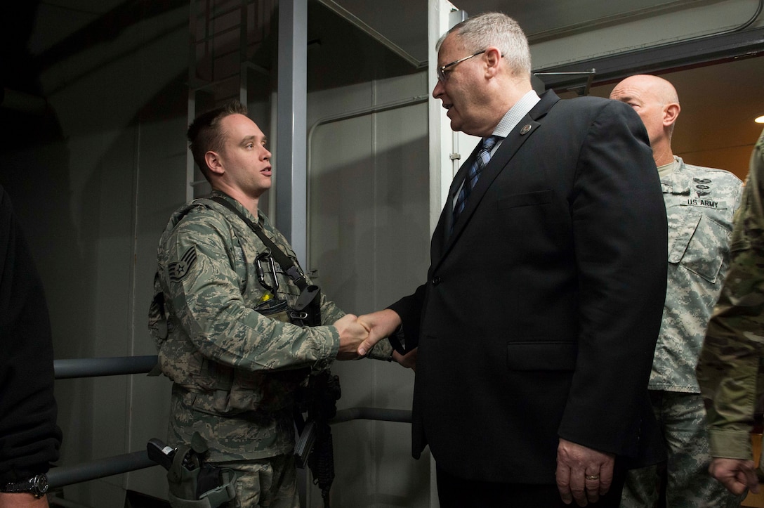 Deputy Defense Secretary Bob Work greets an airman on Cheyenne Mountain Air Force Station, Colo., Dec 18, 2015. Work is in Colorado to meet with defense leaders and tour local commands. DoD photo by Navy Petty Officer 1st Class Tim D. Godbee