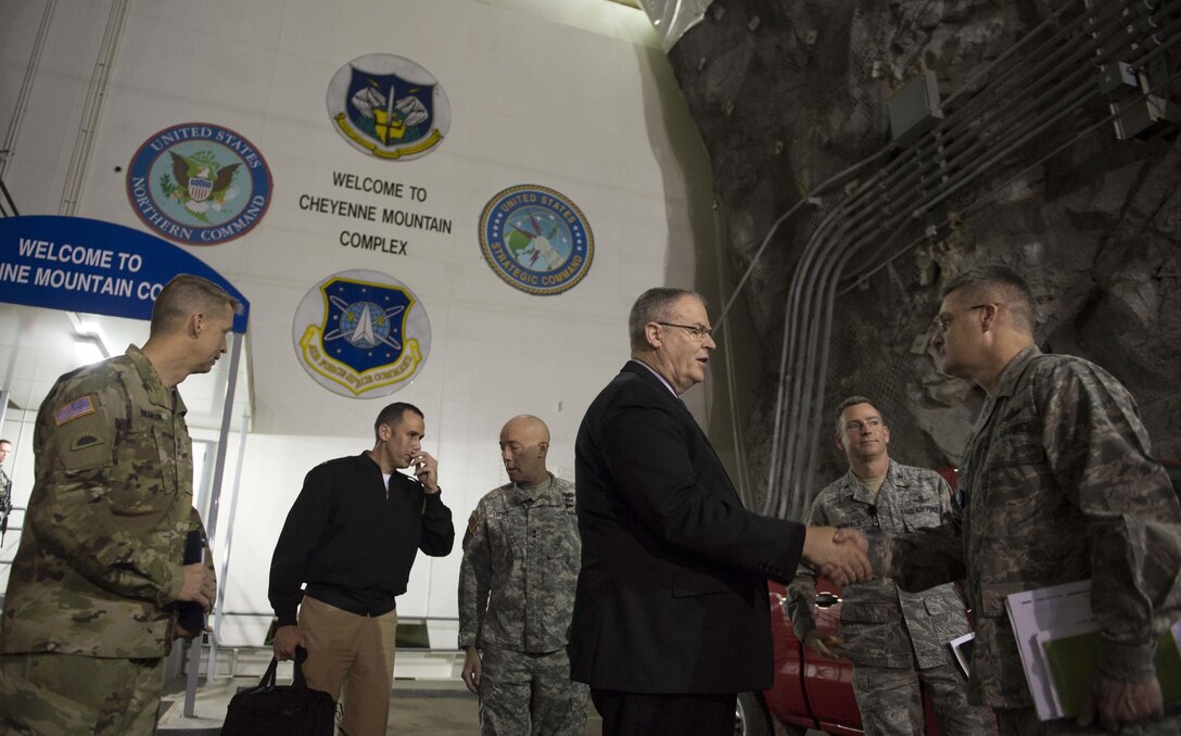 Deputy Defense Secretary Bob Work takes a minute to greet an airman on Cheyenne Mountain Air Force Station, Colo., Dec. 18, 2015. Work is in Colorado to meet with defense leaders and tour local commands. DoD photo by Navy Petty Officer 1st Class Tim D. Godbee
