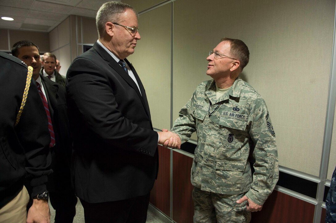Deputy Defense Secretary Bob Work greets an airman at U.S. Northern Command on Peterson Air Force Base, Colo., Dec 18, 2015. Work is in Colorado to meet with defense leaders and tour local commands. DoD photo by Navy Petty Officer 1st Class Tim D. Godbee