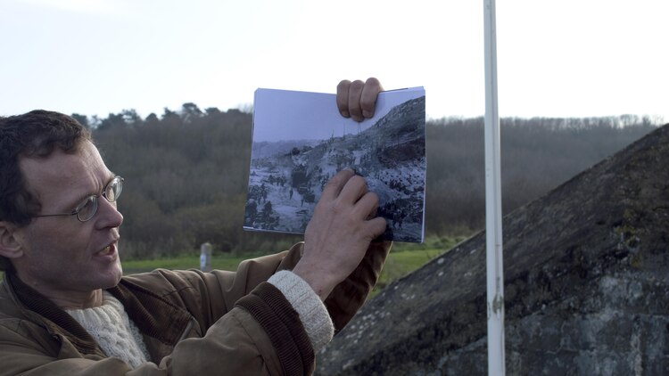 A tour guide shows archived photographs of the historic amphibious Allied landings of D-Day to U.S. Marine noncommissioned officers of U.S. Marine Corps Forces Europe and Africa, Normandy, France, Dec. 11-13. The Marine NCOs are the backbone of service component operations for U.S. European Command that supports numerous NATO-led operations and exercises in Europe that enables the Alliance to continue their proven, enduring partnerships.