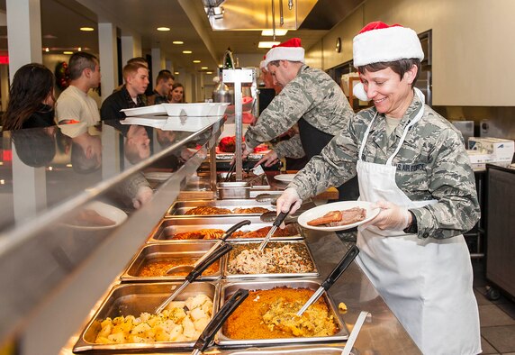 Col. Trisha Sexton, National Air and Space Intelligence Center vice commander, prepares a dinner plate during the 88th Air Base Wing’s annual holiday meal at the Pitsenbarger Dining Facility at Wright-Patterson Air Force Base, Ohio, Dec. 16, 2015.  Each year the dining facility staff prepares a special Christmas themed dinner for patrons. Throughout the evening several Wright-Patterson AFB senior leaders serve the dinner to Airmen as a gesture of appreciation for their hard work. (U.S. Air Force photo by Tech. Sgt. Eunique P. Thomas)