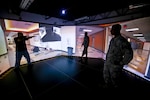 A U.S Air Force Security Forces Airman from the New Jersey Air National Guard's 108th Wing gets feedback from a U.S. Marshal instructor in a firearms training simulator at a U.S. Marshal training site in Lawrenceville, New Jersey, on Dec. 12, 2015. 