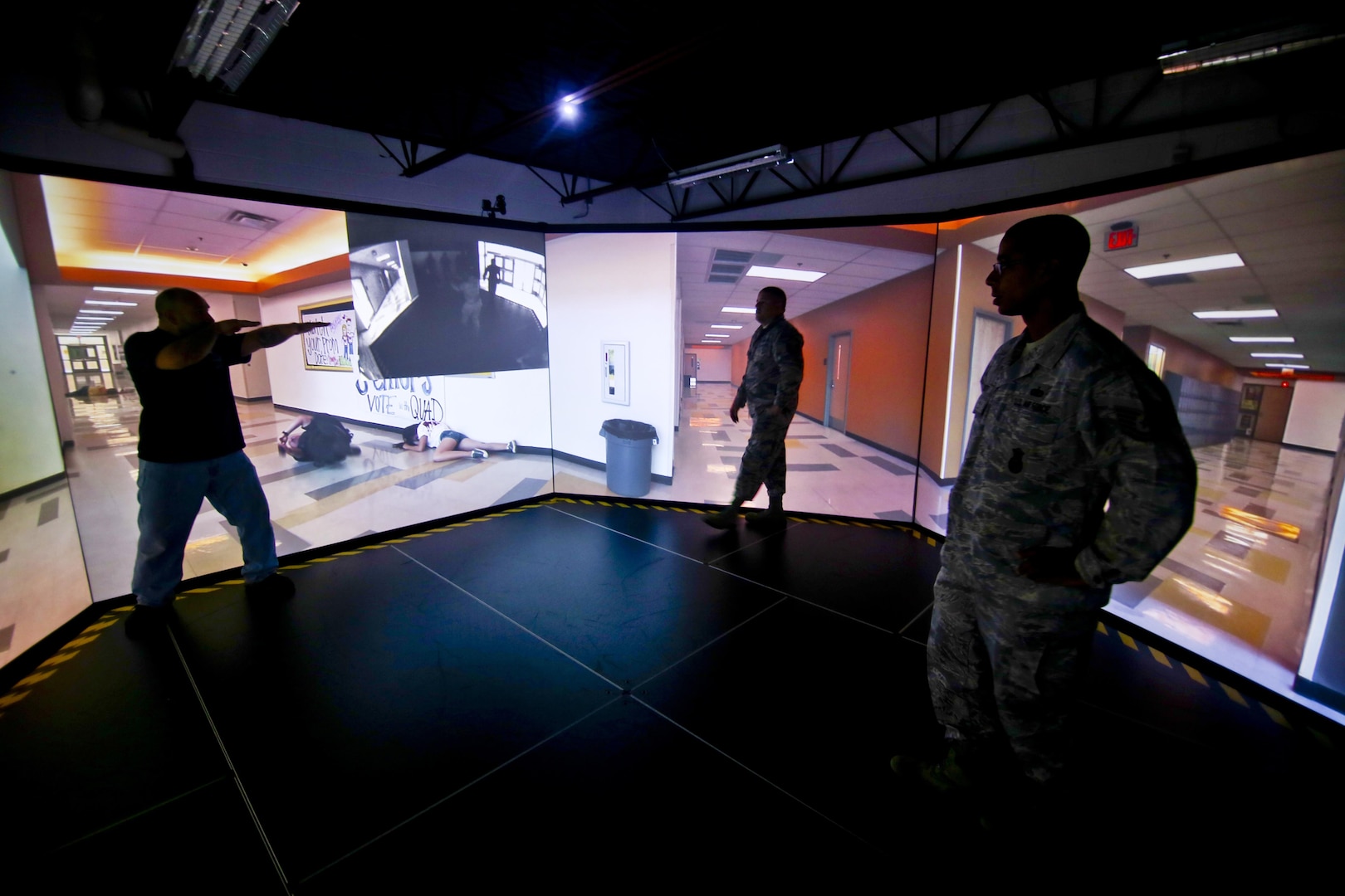 A U.S Air Force Security Forces Airman from the New Jersey Air National Guard's 108th Wing gets feedback from a U.S. Marshal instructor in a firearms training simulator at a U.S. Marshal training site in Lawrenceville, New Jersey, on Dec. 12, 2015. 
