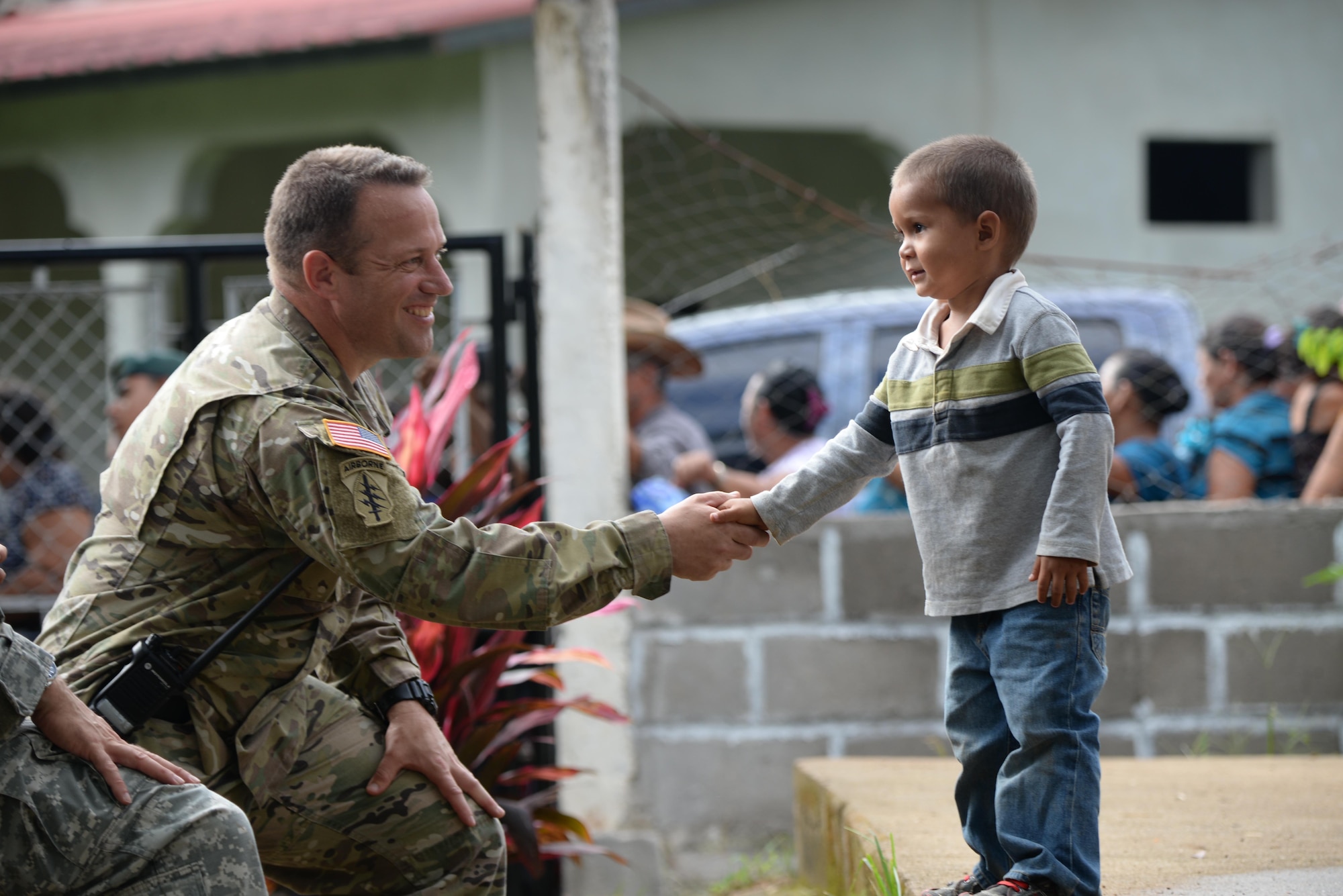 Army Capt. John Dills, the Joint Task Force-Bravo tactical officer in charge, shakes hands with a boy during a medical readiness training exercise in San Jose De Rio Pinto, Honduras, Nov. 12, 2015. The MEDRETE JTF-Bravo supports provide military members with essential training in austere locations and helps build local community relations in the host country. (U.S. Air Force Photo/Senior Airman Westin Warburton)