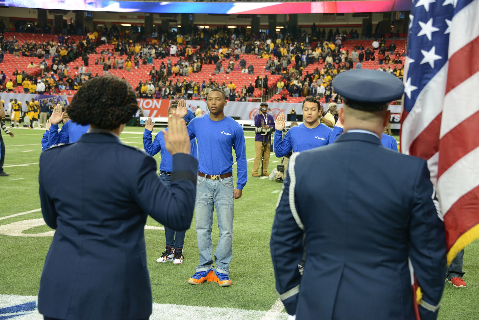 A mass enlistment was held on the field just before kickoff as 12 of the newest Air Force Reservists joined the ranks at the Air Force Reserve Celebration Bowl. The enlistment was conducted by Maj Gen Stayce D. Harris, 22nd Air Force commander, Dobbins Air Reserve Base. (Air Force photo/Master Sgt. Chance Babin)