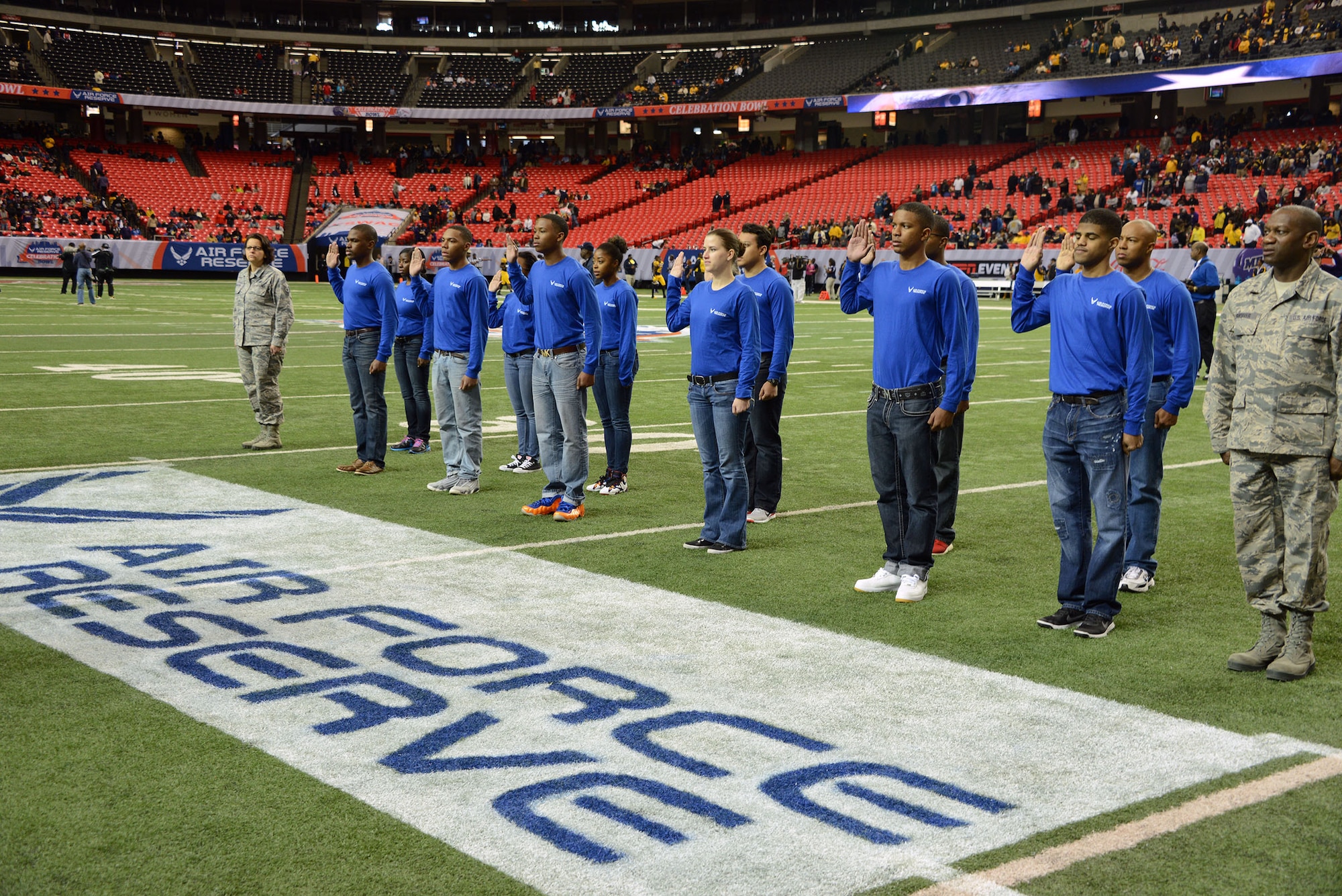 A mass enlistment was held on the field just before kickoff as 12 of the newest Air Force Reservists joined the ranks at the Air Force Reserve Celebration Bowl. The enlistment was conducted by Maj Gen Stayce D. Harris, 22nd Air Force commander, Dobbins Air Reserve Base. (Air Force photo/Master Sgt. Chance Babin)