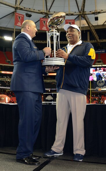 Maj Gen Richard S. Haddad hands out the Air Force Reserve Celebration Bowl championship trophy to North Carolina A&T head coach Rod Broadway. North Carolina A&T won the thriller 41-34 over Alcorn State in the  at the Georgia Dome. (Air Force photo/Master Sgt. Chance Babin)