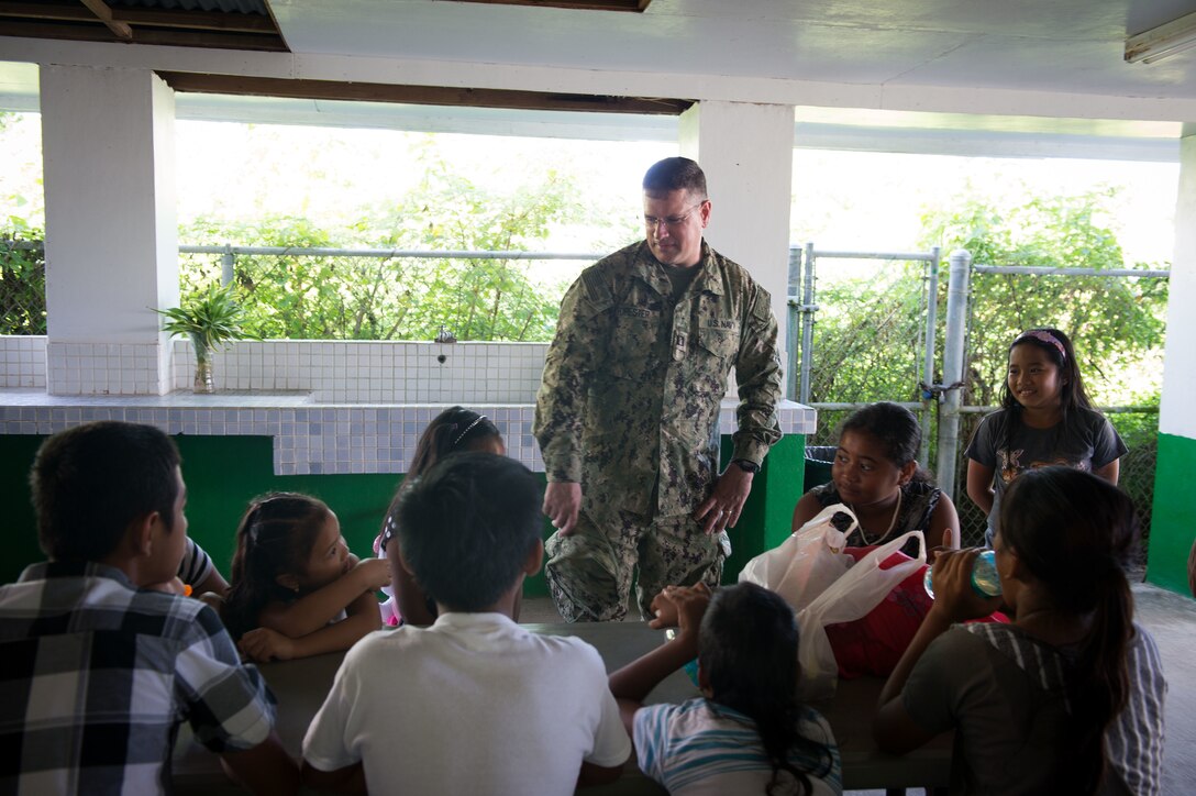 U.S. Navy Lt. Andrew Forester, Naval Base Guam chaplain. assigned to Commander, Task Force 75, meets with local children for Operation Christmas Drop at Saipan, Dec. 20, 2015. Operation Christmas Drop is the longest-running humanitarian airlift operation in the world, and the longest ongoing U.S. military operation. In addition to delivering critical supplies and holiday gifts to the people of the Pacific Islands, Christmas Drop trains U.S. service members to airlift material to remote locations.  U.S. Navy photo by Petty Officer 1st Class Ace Rheaume