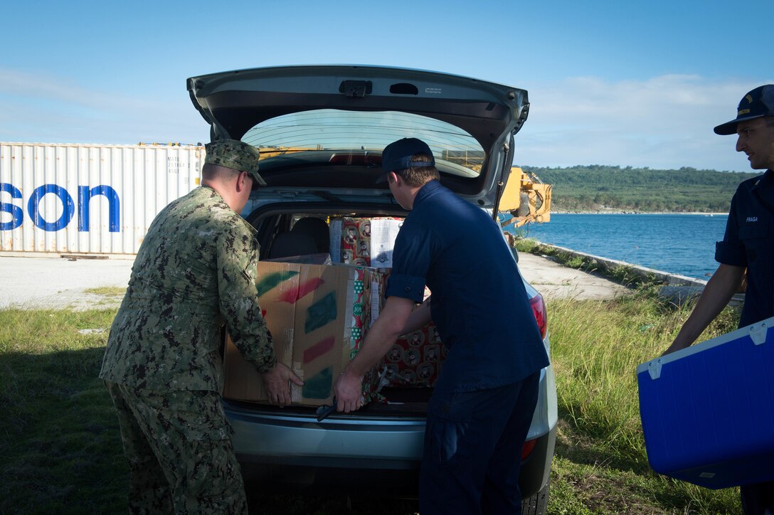 U.S. Coast Guard crew members load supplies for delivery to Tinian for Operation Christmas Drop at Tinian, Dec. 19, 2015.  Operation Christmas Drop is the longest-running humanitarian airlift operation in the world, and the longest ongoing U.S. military operation. In addition to delivering critical supplies and holiday gifts to the people of the Pacific Islands, Christmas Drop trains U.S. service members to airlift material to remote locations. U.S. Navy photo by Petty Officer 1st Class Ace Rheaume