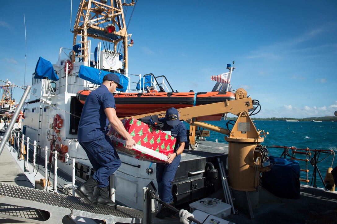 U.S. Coast Guard crew members load supplies for delivery to Tinian and Saipan for Operation Christmas Drop at Naval Base Guam, Dec. 18, 2015. Operation Christmas Drop is the longest-running humanitarian airlift operation in the world, and the longest ongoing U.S. military operation. In addition to delivering critical supplies and holiday gifts to the people of the Pacific Islands, Christmas Drop trains U.S. service members to airlift material to remote locations. U.S. Navy photo by Petty Officer 1st Class Ace Rheaume