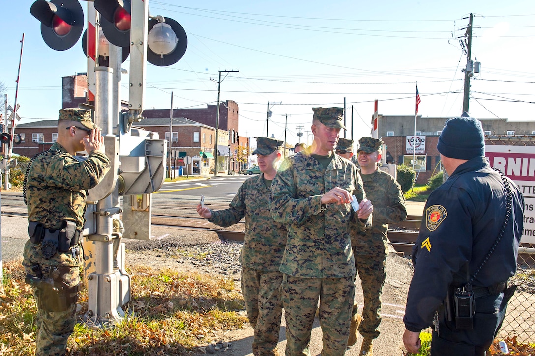 Military police and civilian law enforcement officers with Security Battalion, Marine Corps Base Quantico, check the identification of people who enter the base from the Virginia Railway Express station in the Town of Quantico. Security Battalion Marines routinely conduct random ID checks on people who ride the VRE trains and access the base through the Town of Quantico. In an effort to increase the security of the base and the safety of the people who work aboard the base, Security Battalion Marines maintain increased awareness at base access points.