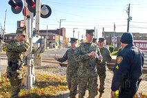 Military police and civilian law enforcement officers with Security Battalion, Marine Corps Base Quantico, check the identification of people who enter the base from the Virginia Railway Express station in the Town of Quantico. Security Battalion Marines routinely conduct random ID checks on people who ride the VRE trains and access the base through the Town of Quantico. In an effort to increase the security of the base and the safety of the people who work aboard the base, Security Battalion Marines maintain increased awareness at base access points.