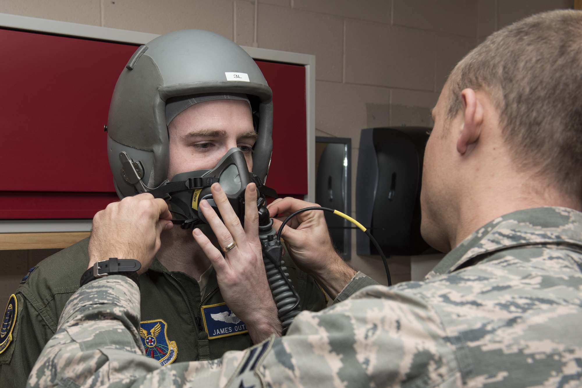 Capt. James Outland, 54th Helicopter Squadron from Minot Air Force Base, N.D., gets fitted for a mask before entering the high altitude chamber at the Aerospace and Operational Physiology Lab on Dec. 10, 2015. The high altitude chamber, one of 11 in the Air Force, gives pilots and aircrew members an understanding of how the human body reacts to altitudes and low oxygen. (U.S. Air Force photo by Senior Airman Rose Gudex)