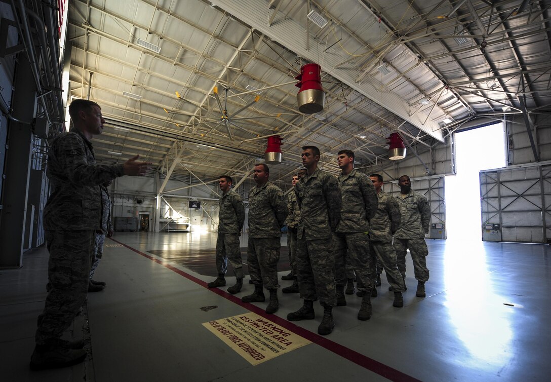 Crew chiefs with the 1st Special Operations Aircraft Maintenance Squadron, attend role call before their shift begins at Hurlburt Field, Fla., Dec. 15, 2015. Crew chiefs with the 4th Aircraft Maintenance Unit are trained to diagnose malfunctions on the AC-130U Spooky Gunship during pre-flight and post-flight inspections, repair and refuel the aircraft, keep detailed records, marshal aircraft, to remain mission ready at all times. (U.S. Air Force photo by Senior Airman Meagan Schutter)