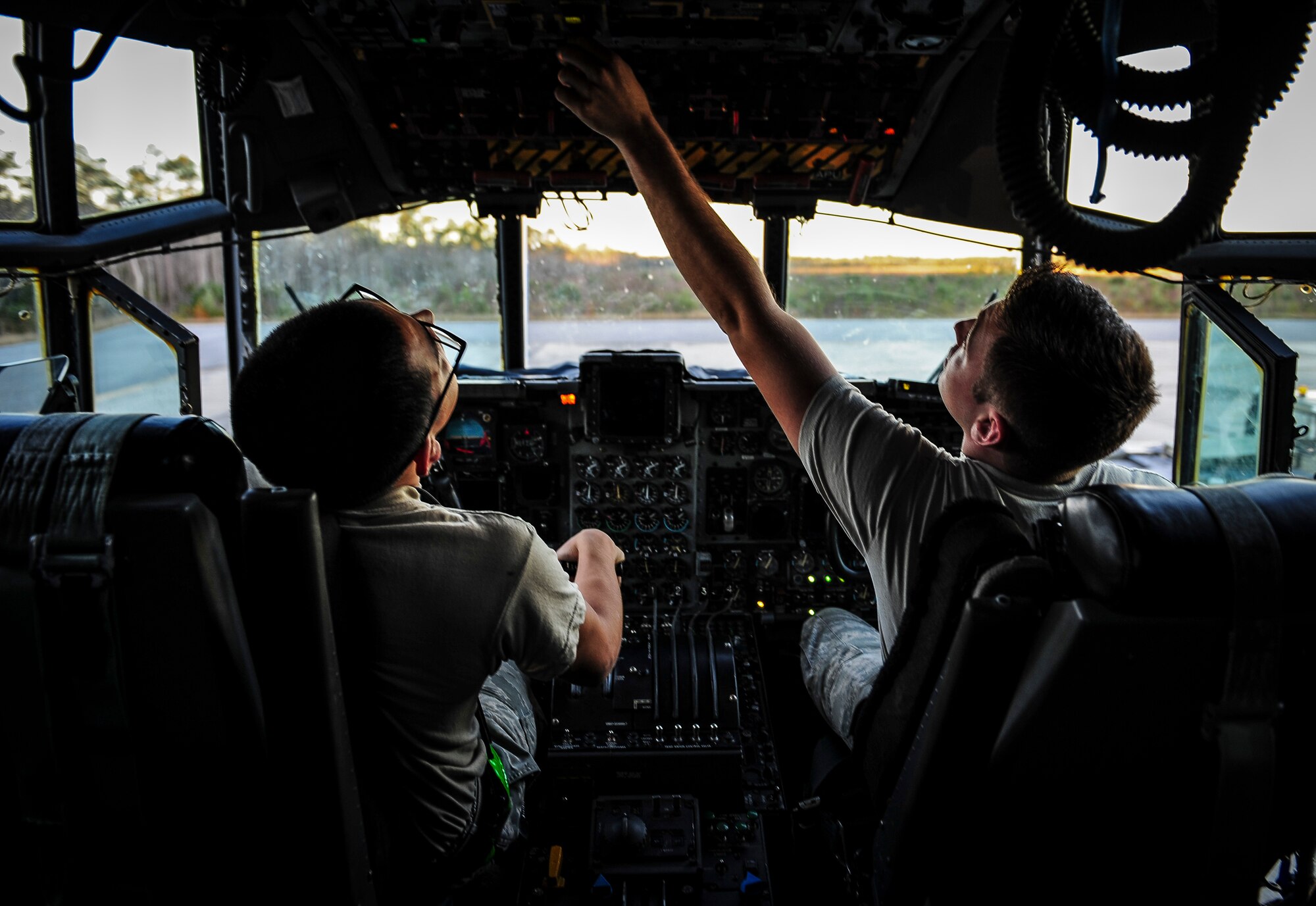 Senior Airmen Kristopher Benfer and Fernando Cardenas, crew chiefs with the 1st Special Operations Aircraft Maintenance Squadron, start the auxiliary power unit on an AC-130U Spooky Gunship at Hurlburt Field, Fla., Dec. 15, 2015. Primary missions of the AC-130U are close air support, air interdiction and armed reconnaissance. (U.S. Air Force photo by Senior Airman Meagan Schutter)