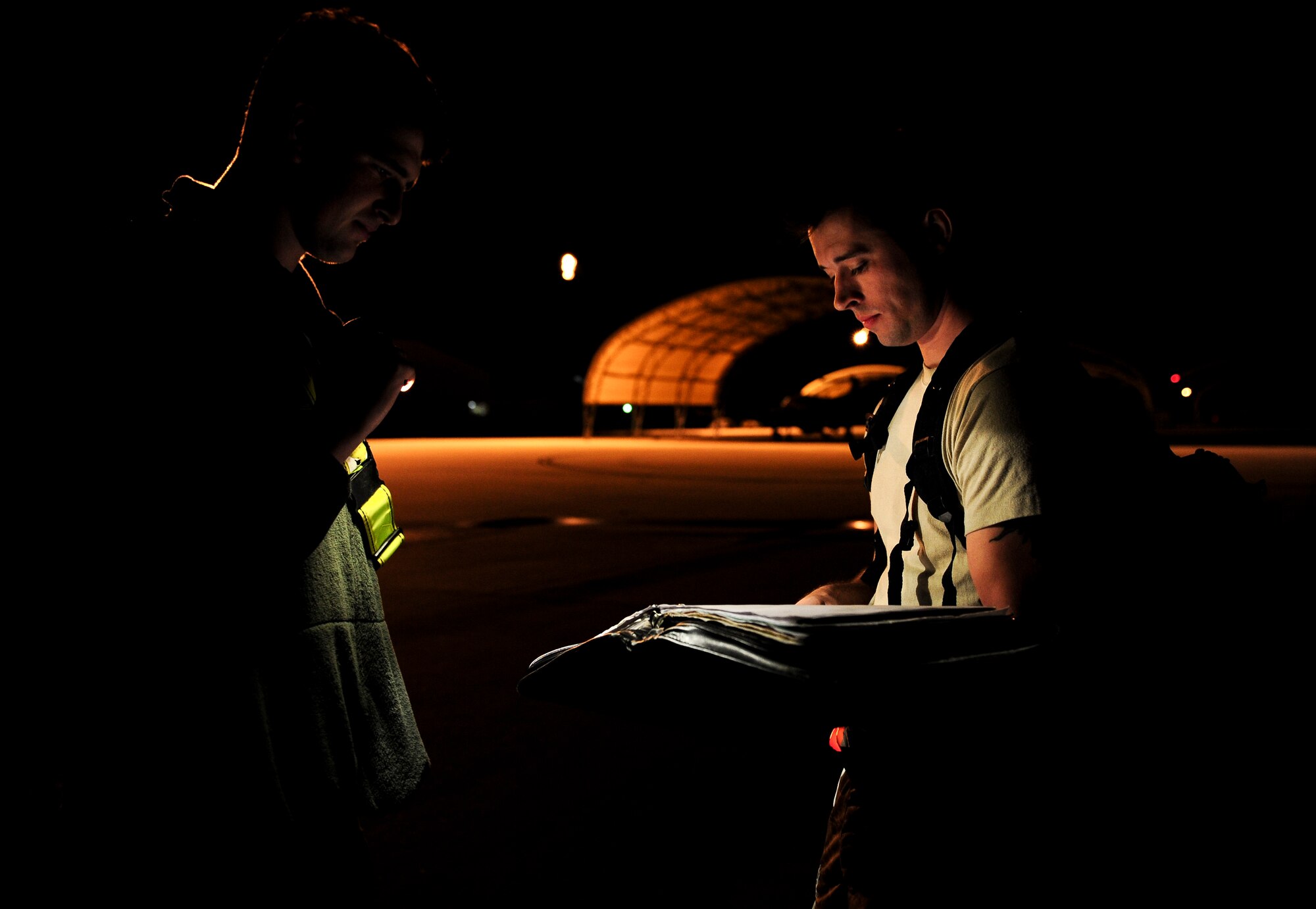 Senior Airman Corey Southerland and Airman 1st Class Nolan Davis, crew chiefs with the 1st Special Operations Aircraft Maintenance Squadron, check aircraft forms for discrepancies during routine maintenance at Hurlburt Field, Fla., Dec. 15, 2015. Crew chiefs with the 4th Aircraft Maintenance Unit are trained to diagnose malfunctions on the AC-130U Spooky Gunship during pre-flight and post-flight inspections, repair and refuel the aircraft, keep detailed records, marshal aircraft, to remain mission ready at all times. (U.S. Air Force photo by Senior Airman Meagan Schutter)